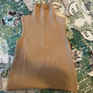 The Row camel sleeveless cashmere turtleneck.